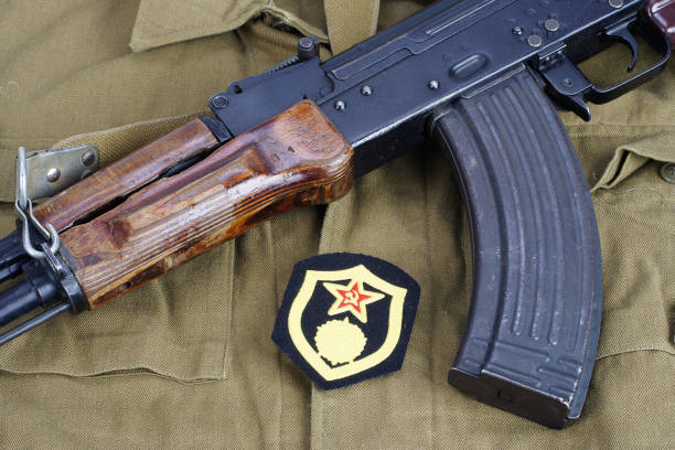 istock AK47 with Soviet Army chemical troops shoulder patch on khaki uniform background 949243954