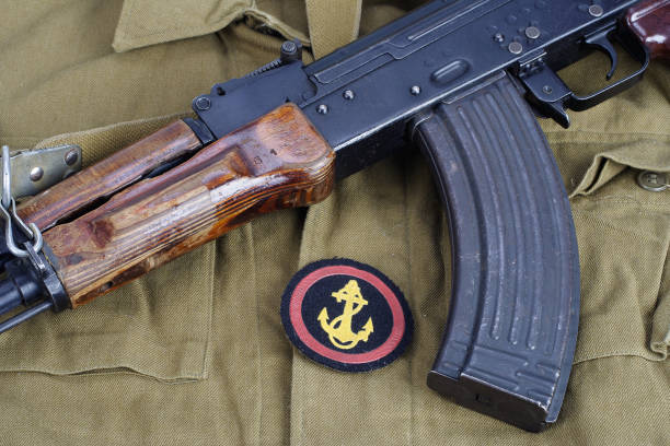 istock AK47 with Soviet Army Marines shoulder patch on khaki uniform background 949244212