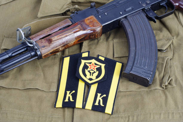 istock AK47 with Soviet Army Cadet shoulder mark and Soviet Army Transportation Corps shoulder patch on khaki uniform background 949244338