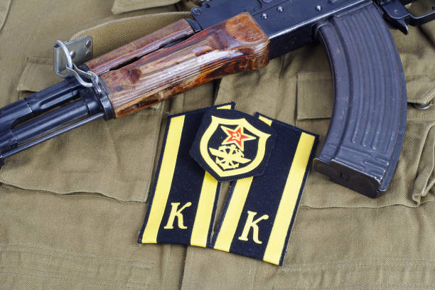 istock AK47 with Soviet Army Cadet shoulder mark and Soviet Army Military engineer shoulder patch on khaki uniform background 949244354
