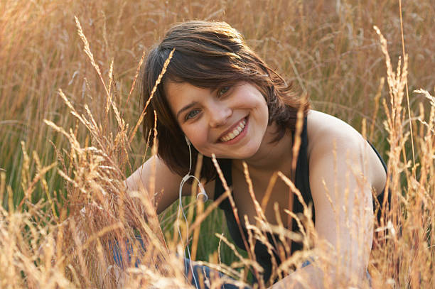 istock The smiling girl in a grass 94924685