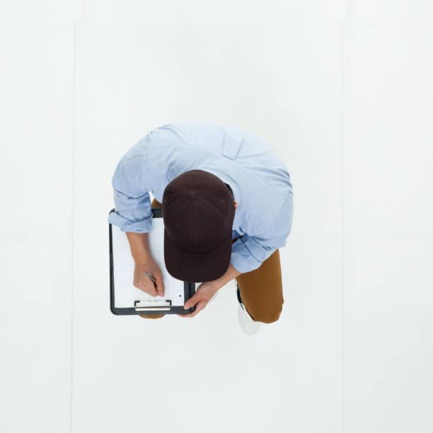 istock Top down view of Korean man seated and using clipboard 949247818