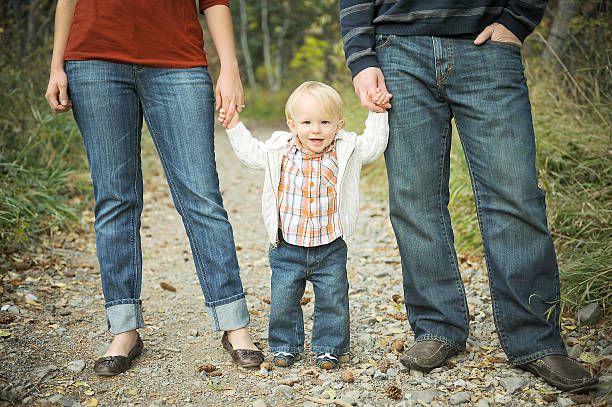 istock Baby smiling holding mom and dad's hand. 94924916