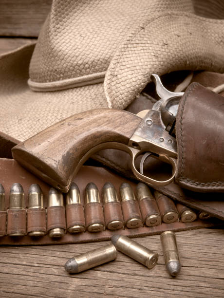istock Hand Gun In Holster With Bullets And Hat 949259758