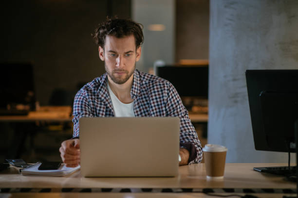 istock Man working on lap top in the office 949259960