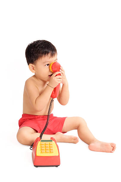 istock Young Boy Playing With Toy Phone 94926328