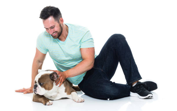 istock Happy young man playing with his bulldog 949269000