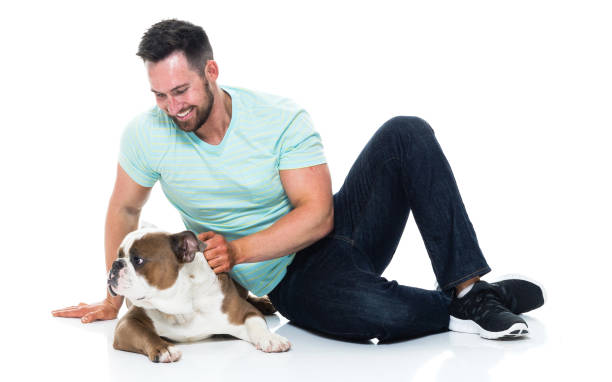 istock Happy young man playing with his bulldog 949269118