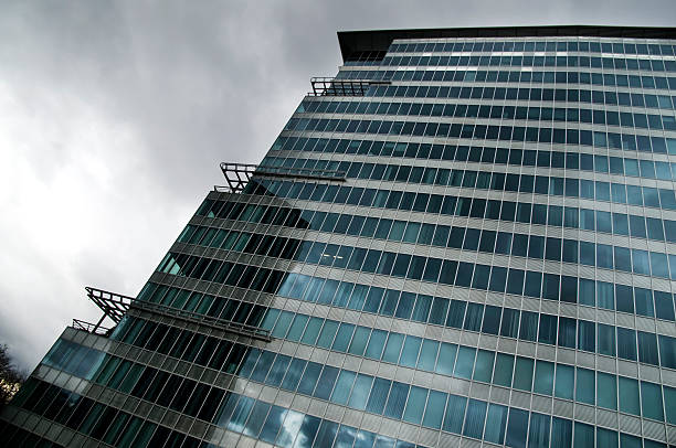 istock Glass building facade against cloudy sky 94927510