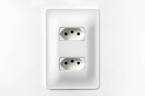 Double plug socket on the wall isolated on white background stock photo