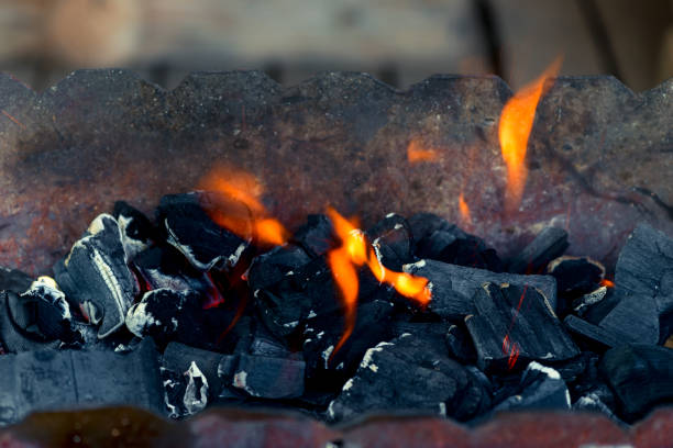 istock orange flame and black coals - bonfire close-up 949278164