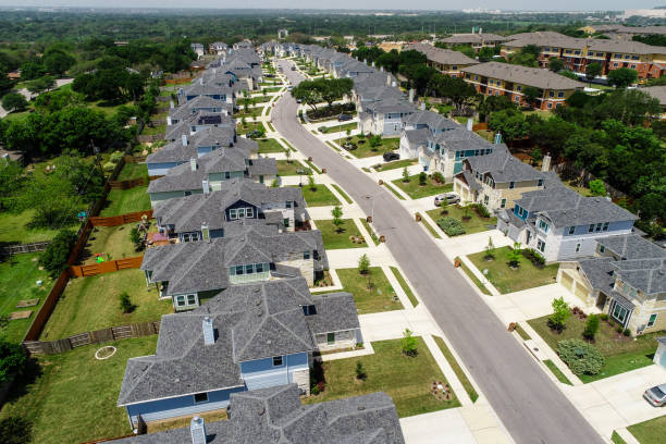 istock urban Suburb development North Austin homes and grey modern rooftops over long street 949285888