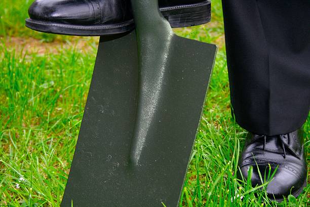 Business man digging a hole stock photo