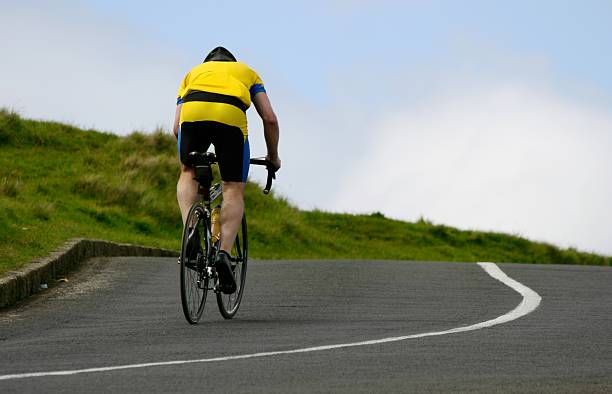 Cyclist riding uphill stock photo