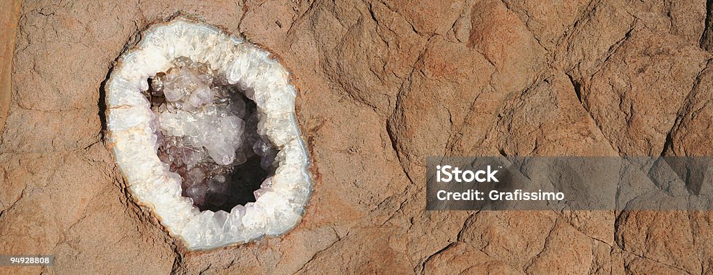 Amethyst on brown rock  Mining - Natural Resources Stock Photo
