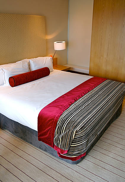 istock Bed in a five star hotel room 94928908