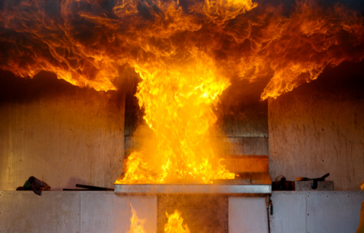 Fire and flames consume the national flag of France.