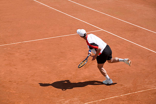 テニス選手かさばるボール - tennis serving men court ストックフォトと画像
