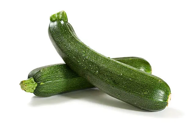 Photo of two fresh zucchini isolated