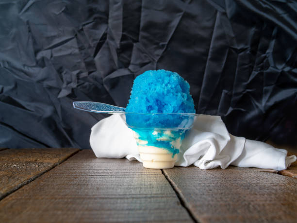 istock Hawaiian Shaved ice, Shave ice, snow cone or snow cone in a clear plastic cup with ice cream on the bottom. 949296328
