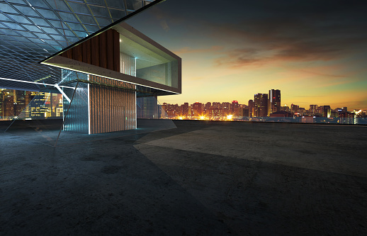 Perspective view of empty cement floor with steel and glass modern building exterior . 3D rendering and real images mixed media .
