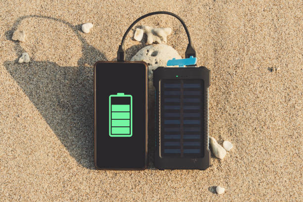 portable solar panel is on the beach - recharger imagens e fotografias de stock