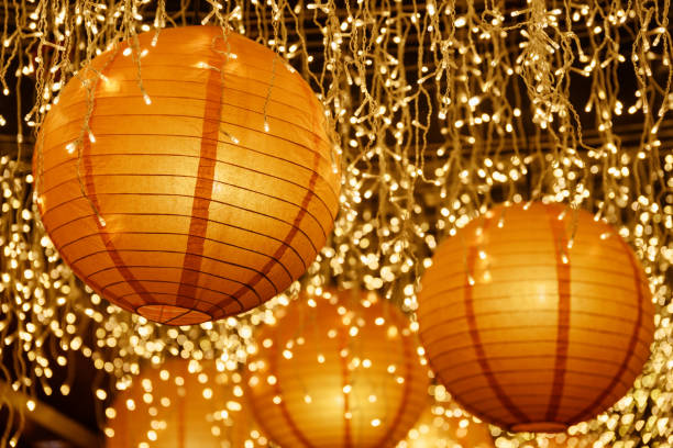 istock Scenic paper lanterns among white lights. Wonderful decoration 949302264