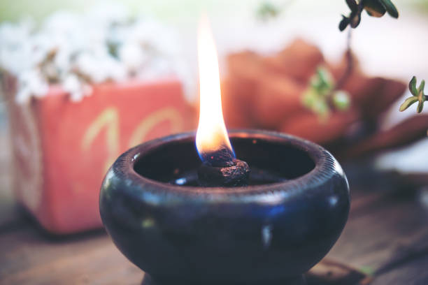 istock Candle flame in black earthen lamps 949306550