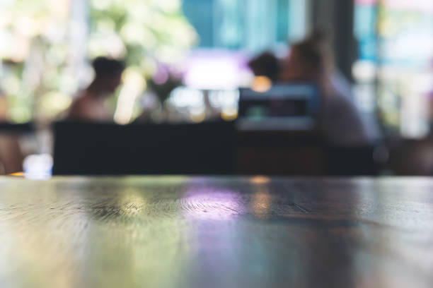 istock Wooden table in cafe with blur bokeh abstract 949306976