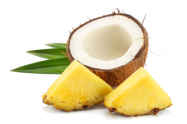 istock Coconut with pineapple and green leaves isolated on white background 949321544