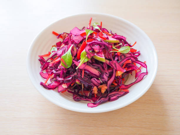 istock Red cabbage salad with apples and pecan nuts for Christmas dinner. Vegetarian dish. 949329282