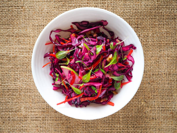 istock Red cabbage salad with apples and pecan nuts for Christmas dinner. Vegetarian dish. 949331490