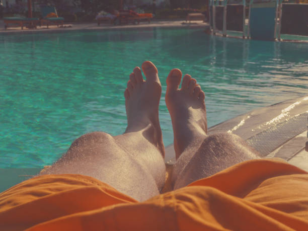 istock Man enjoying at the swimming pool on a hot summer day. 949336028