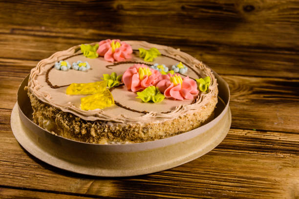 istock Kiev cake with cream on wooden table 949336462
