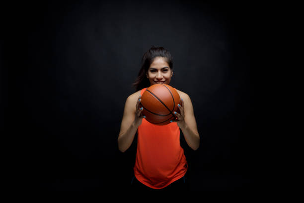 istock Cute female holding sports ball 949337066