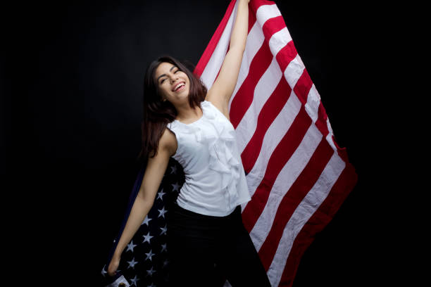 istock Businesswoman holding American flag 949337084