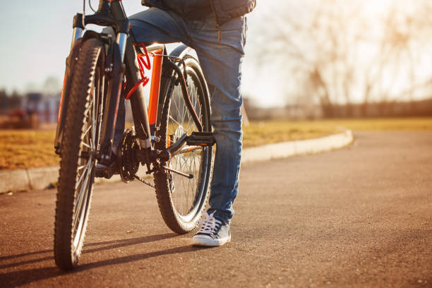 istock Child on a bicycle at asphalt road in sunny spring day. 949340652