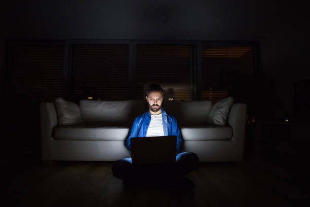 istock A man working on a laptop at home at night. 949346666