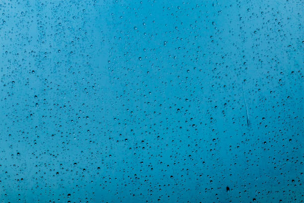 istock drops of rain on a glass on a multicolored background 949347688