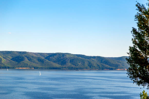 istock boats with white sails float on the background of mountains 949347868