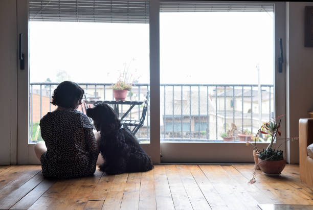 sad woman sitting and looking out the window