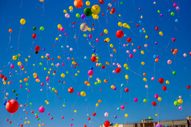 istock Multicolored balloons fly in the blue sky 949351238