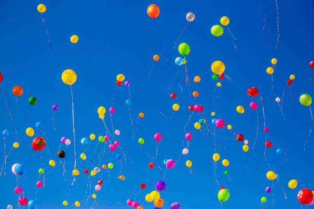 istock Multicolored balloons fly in the blue sky 949351286