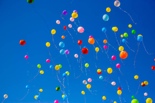 istock Multicolored balloons fly in the blue sky 949351350