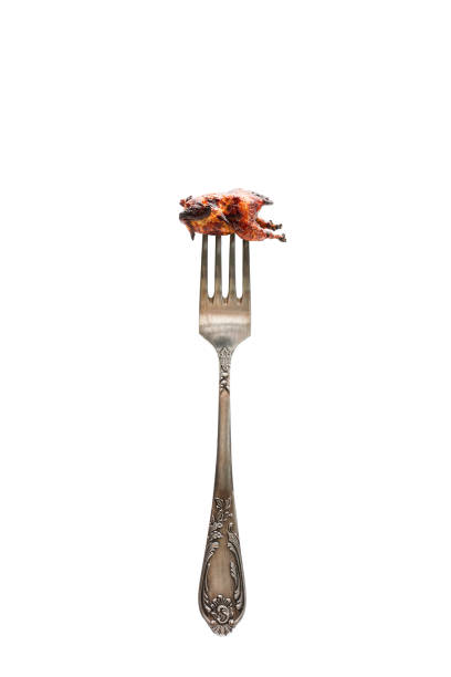 istock Small  grilled chicken on a big fork. Food balance choice portion concept. 949351488