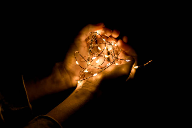 istock Hands hold lights in the evening in the garden 949351896