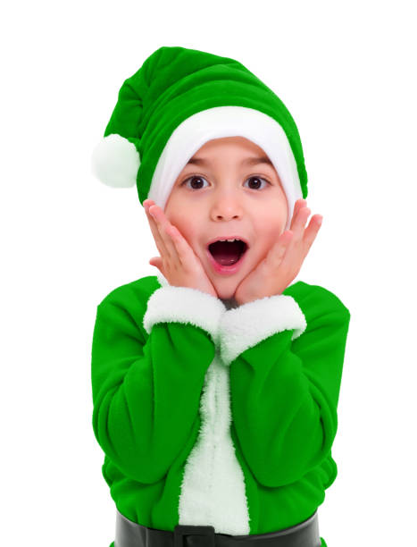 Little boy in green Santa Claus costume stock photo