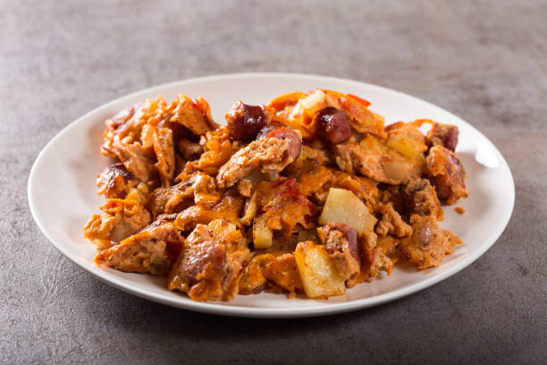 istock Omelette made from eggs, potatoes, sausages and tomato sauce 949352806