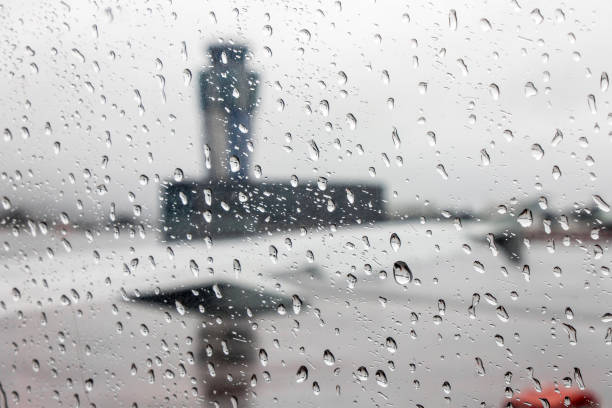 Views of the Santiago de Compostela - Lavacolla Airport air traffic control tower on a rainy day, through an aircraft window covered with raindrops, Spain