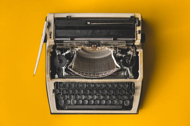 istock Old Retro Typewriter On A Yellow Background, Top View. Creative Journalism Blogger Concept 949356332
